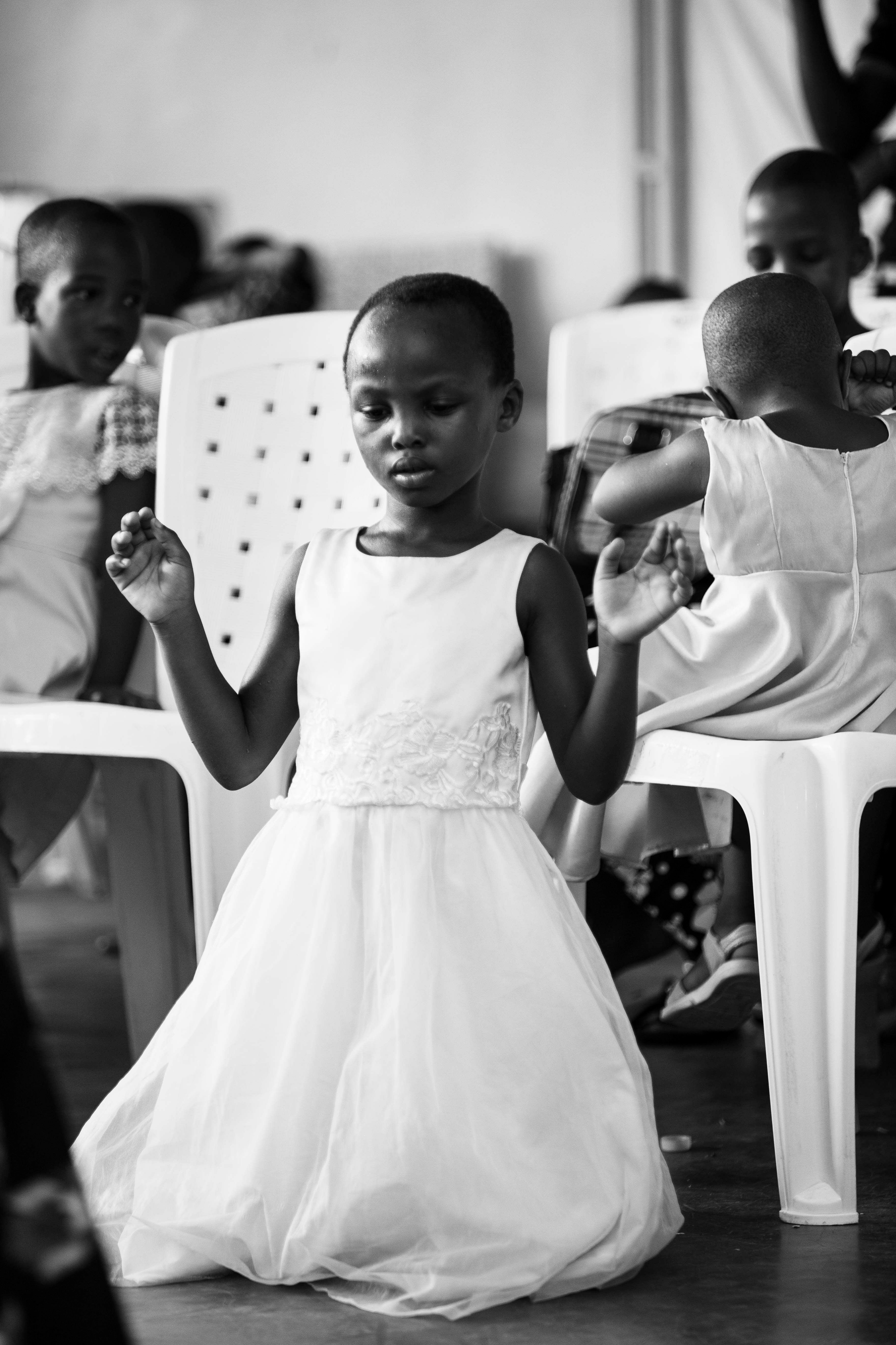 Monochrome Photo of a Girl in a Dress Kneeling · Free Stock Photo