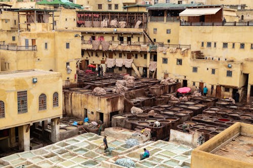 Traditional Fabric Dyeing Process on a Patio and Yellow Architecture