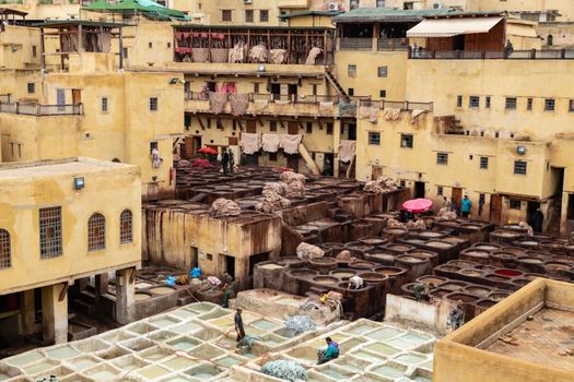 Traditional Fabric Dyeing Process on a Patio and Yellow Architecture