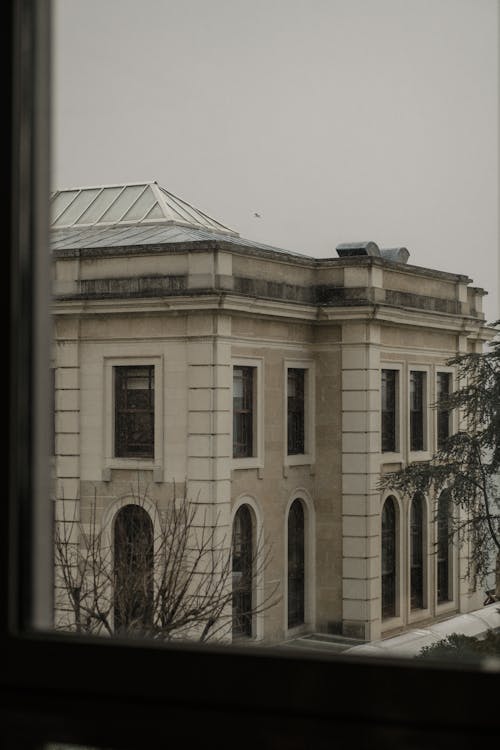 Concrete Building With Arched and Glass Windows