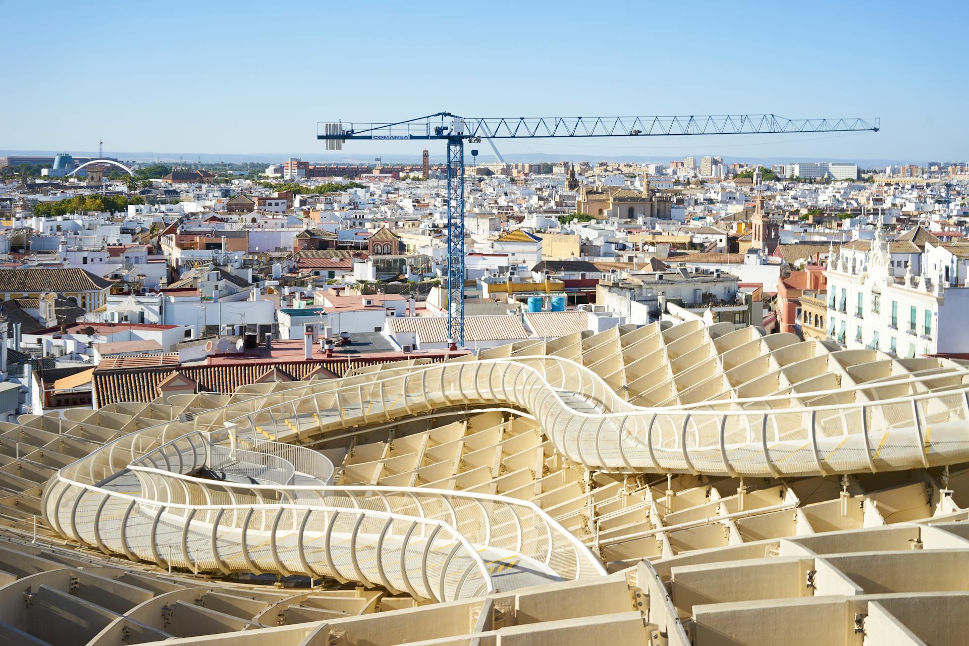 A stunning aerial view of Seville showcasing the Metropol Parasol and cityscape in bright daylight.