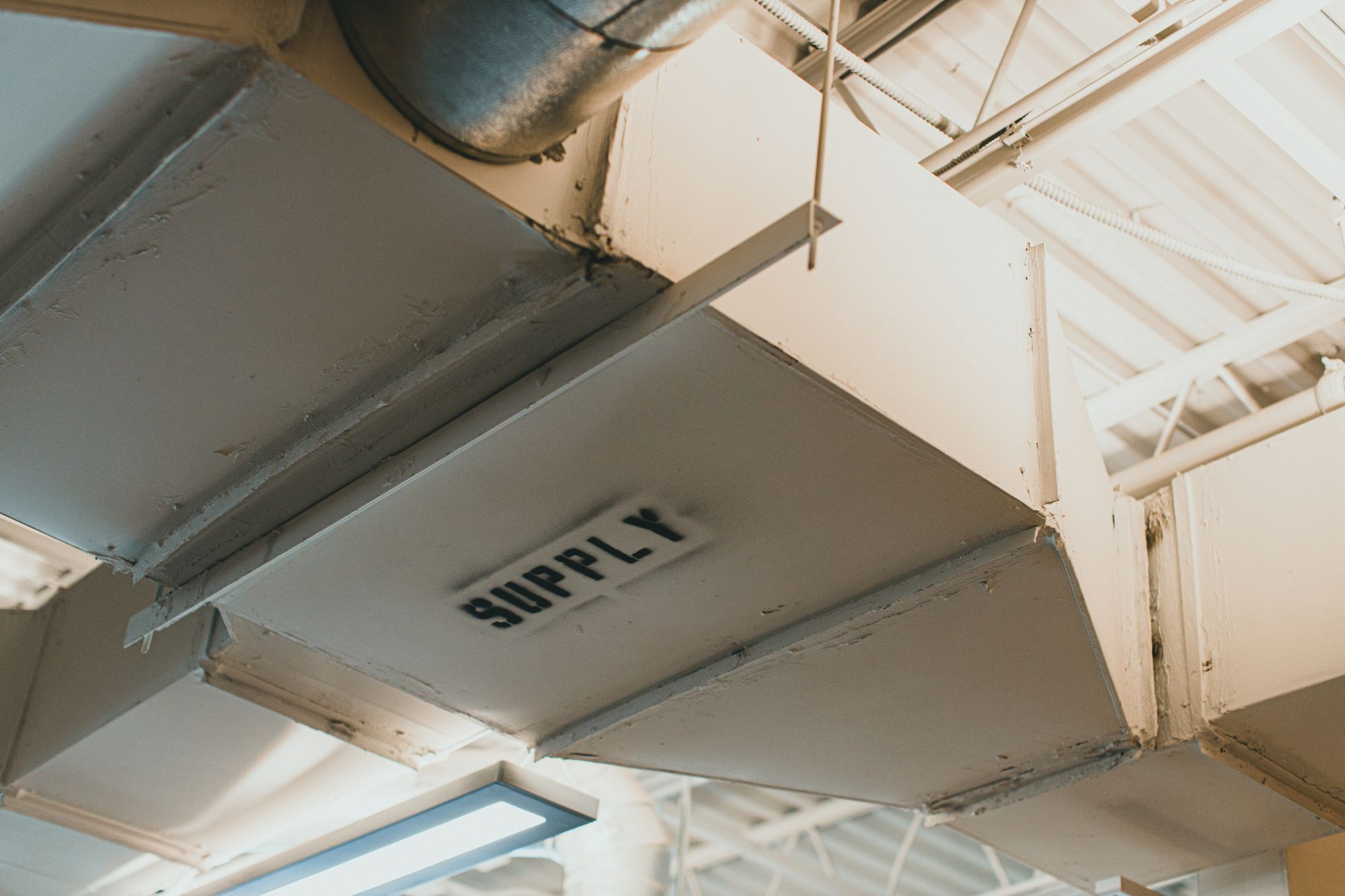 Industrial ventilation ductwork labelled SUPPLY.