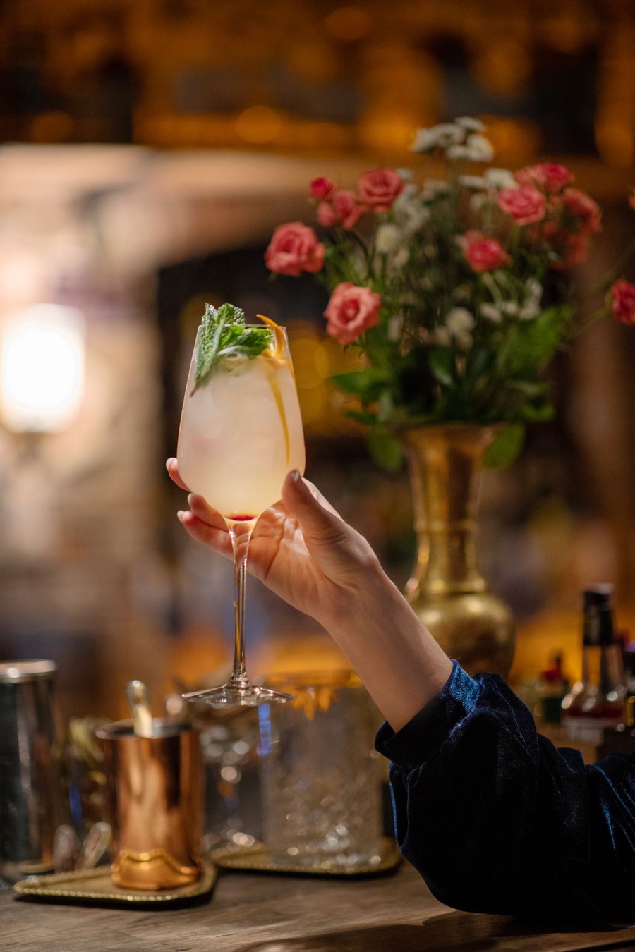 Woman holding a cocktail at the bar