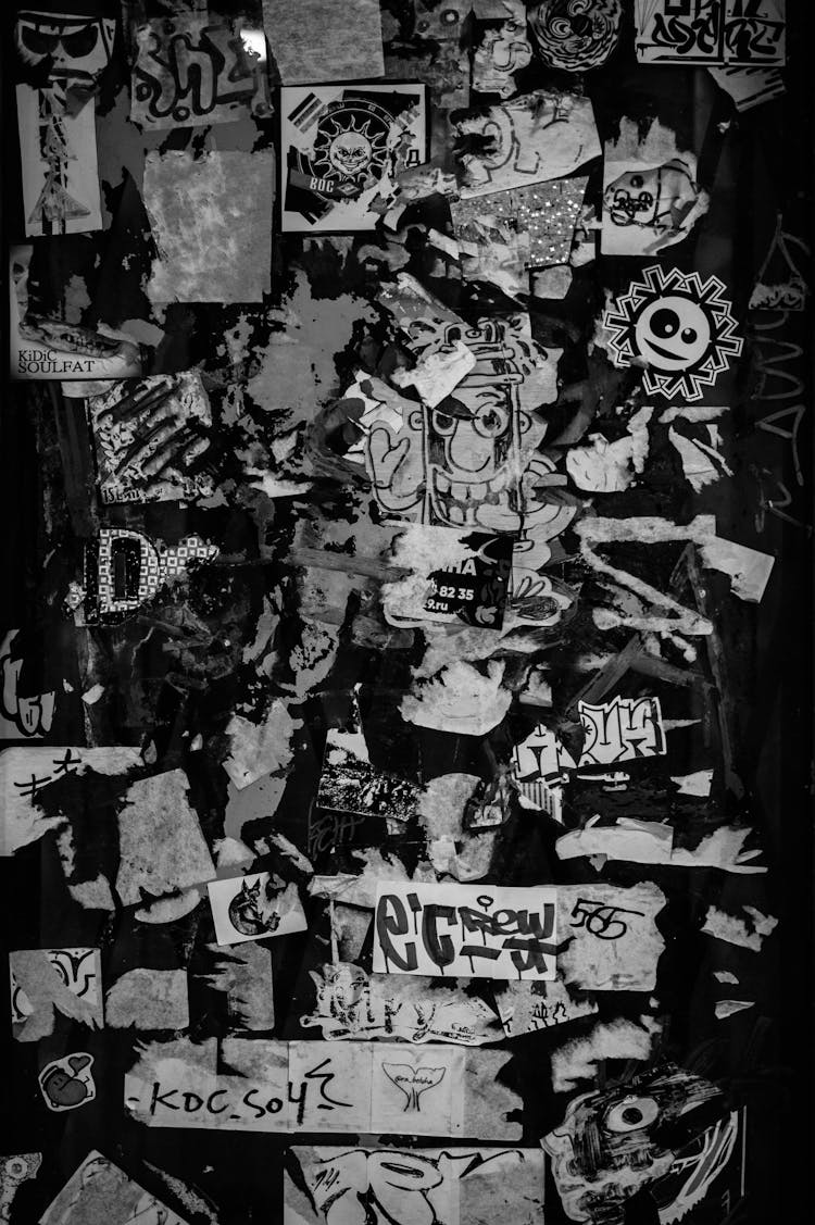 Grayscale Photo Of Stickers On The Wall