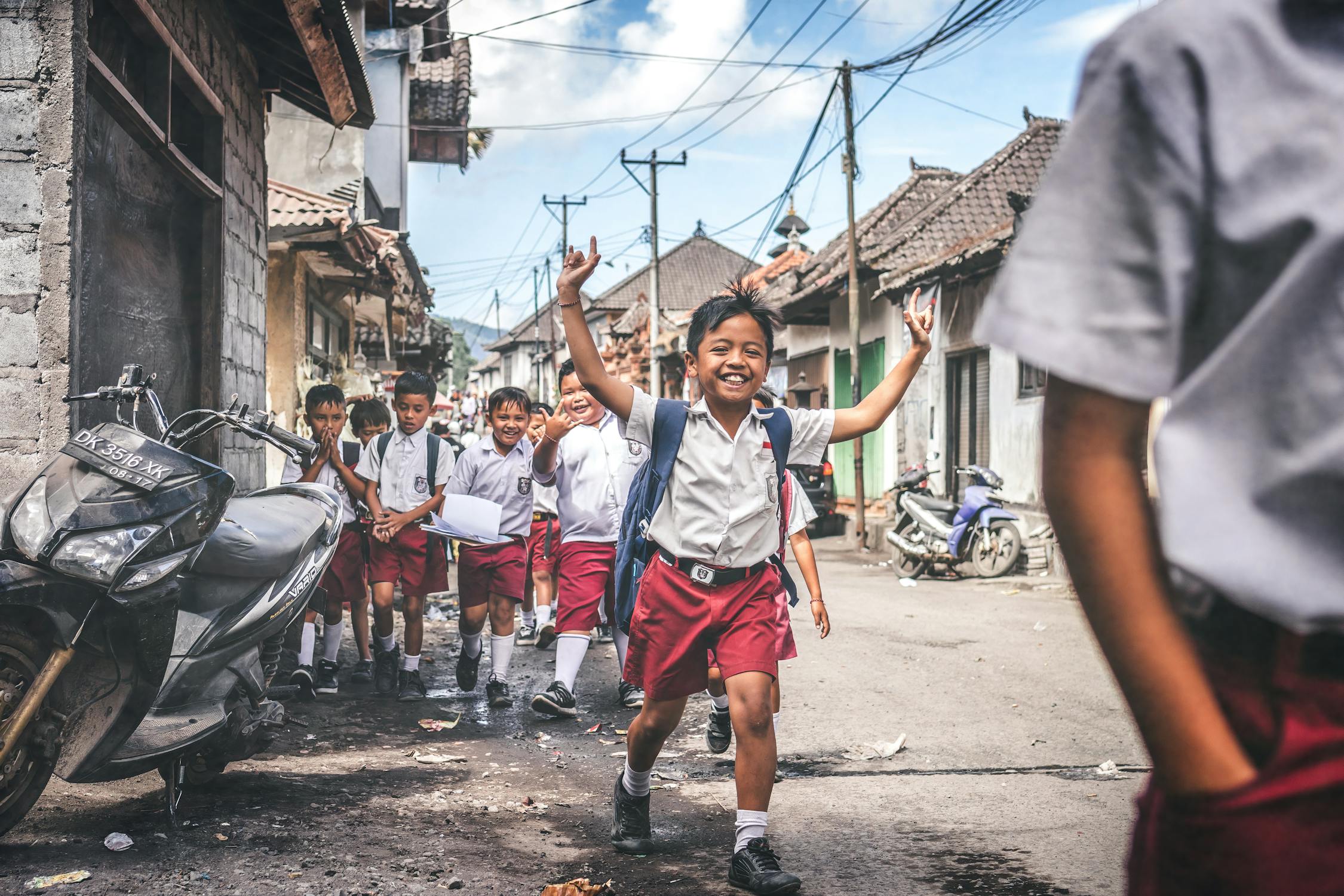 Human Rights by Photo by Artem Beliaikin from Pexels: https://www.pexels.com/photo/boy-in-white-and-red-school-uniform-raising-hands-outdoors-1153976/