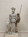 Angel Holding Stick Statue Near White Wall Tiles