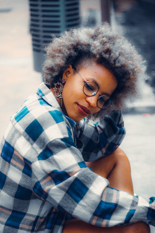 A Woman Wearing a Plaid Shirt and Eyeglasses