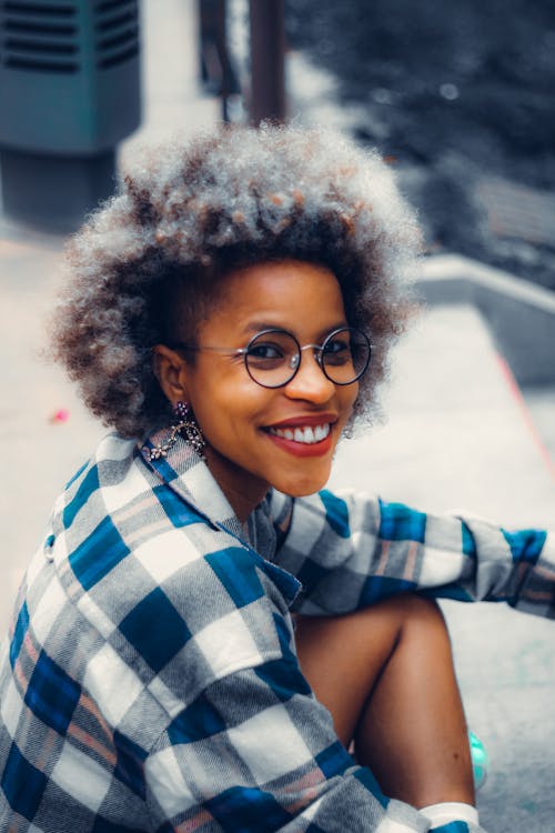 A Woman in Blue and White Plaid Long Sleeves Wearing Black Framed Eyeglasses