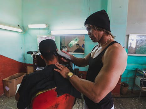 A barber trims a client's hair in an authentic, rustic barbershop setting, capturing a professional moment.