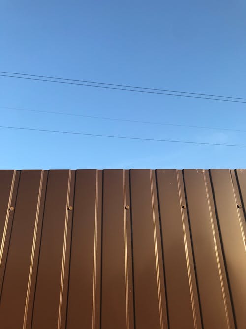 grátis Foto profissional grátis de cerca, céu azul, parede marrom Foto profissional