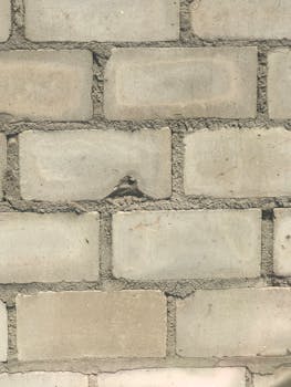 High-resolution close-up of a concrete brick wall showcasing texture and pattern.