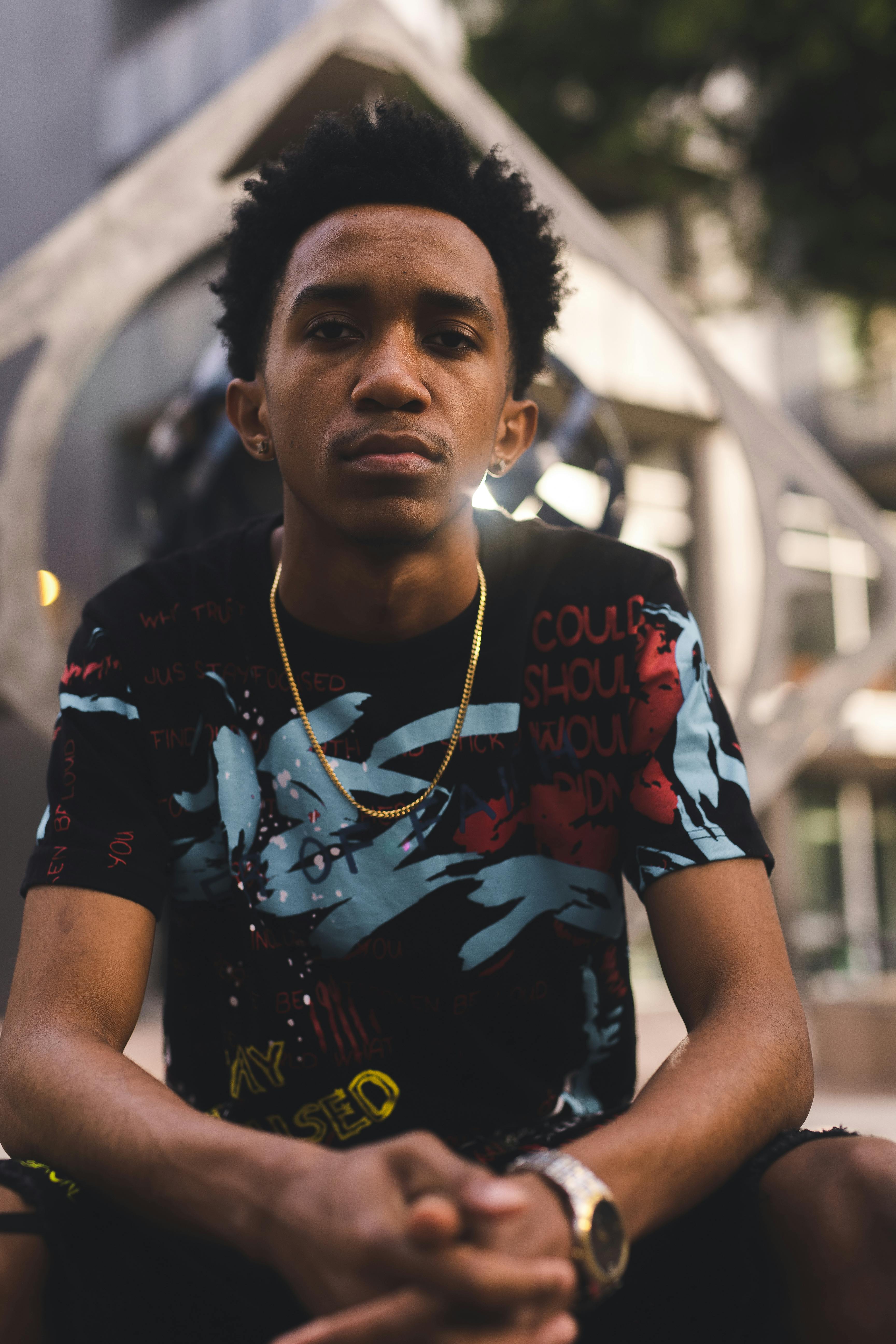 Portrait of a stylish young man posing outdoors with urban background.