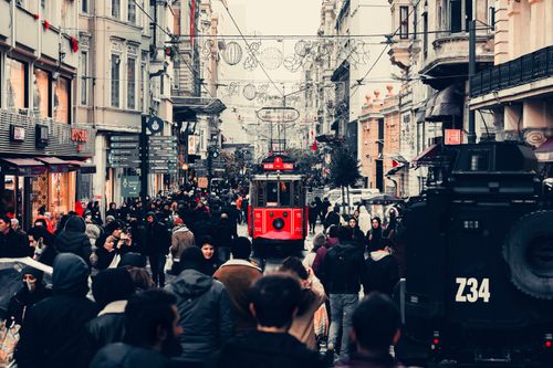 Free Crowded street in Beyoğlu, Istanbul showcasing a vibrant scene with historic red tram and bustling crowd. Stock Photo