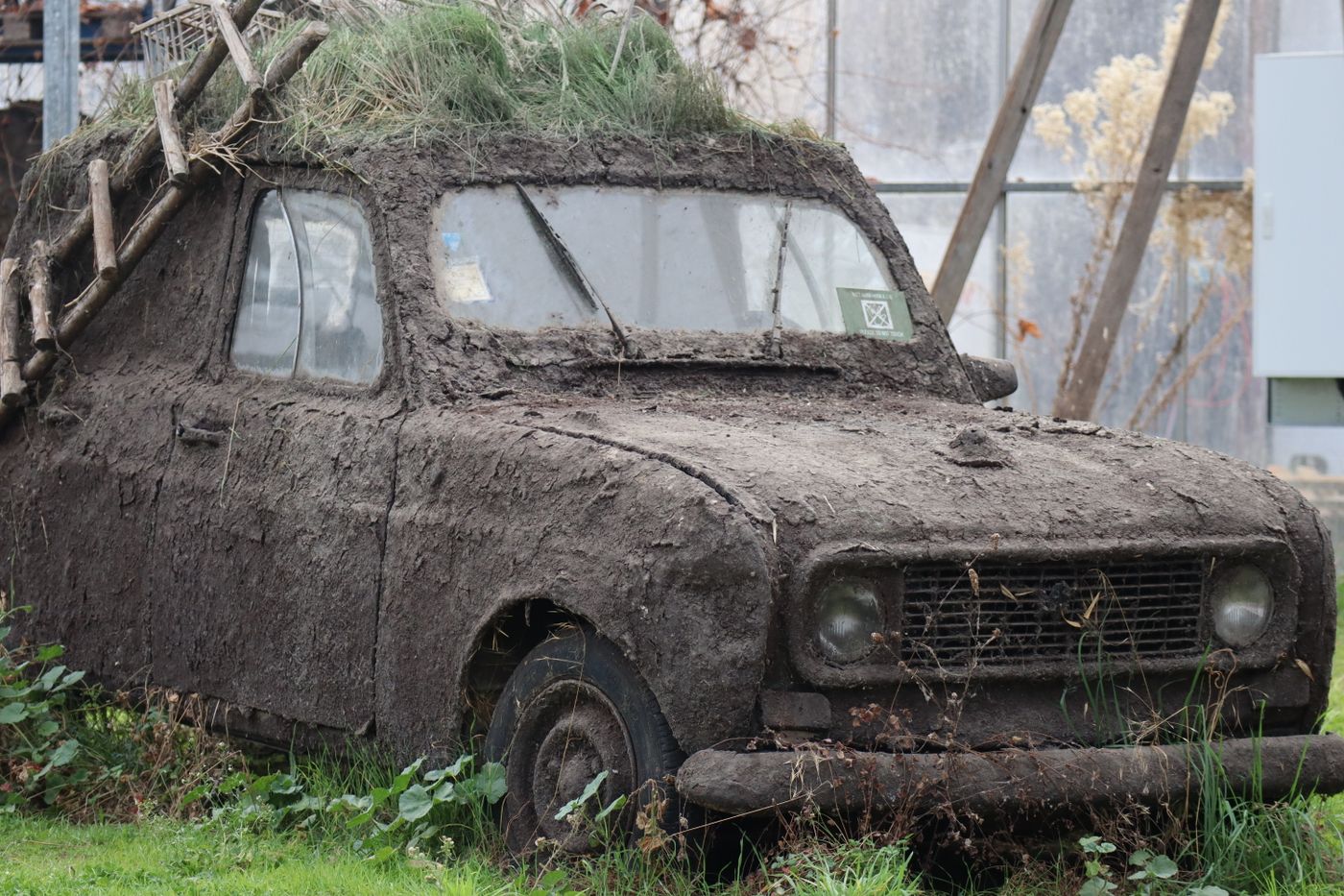 Before: car covered in mud and damage before panel repair