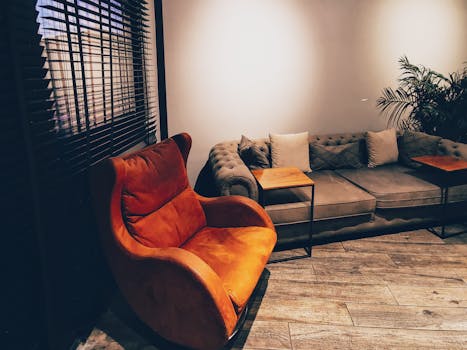 Chic living room interior featuring a modern armchair and plush sofa. Perfect for home decor inspiration.