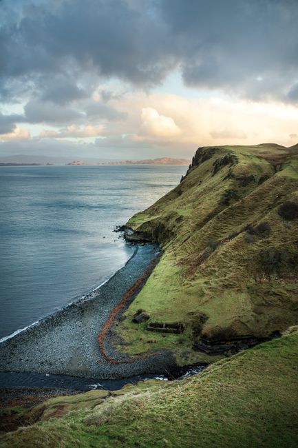 Breathtaking view of cliffs and ocean in Highland, Scotland during sunset.