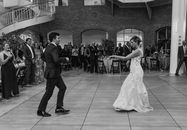 Grayscale Photo of Bride and Groom Dancing on the Street