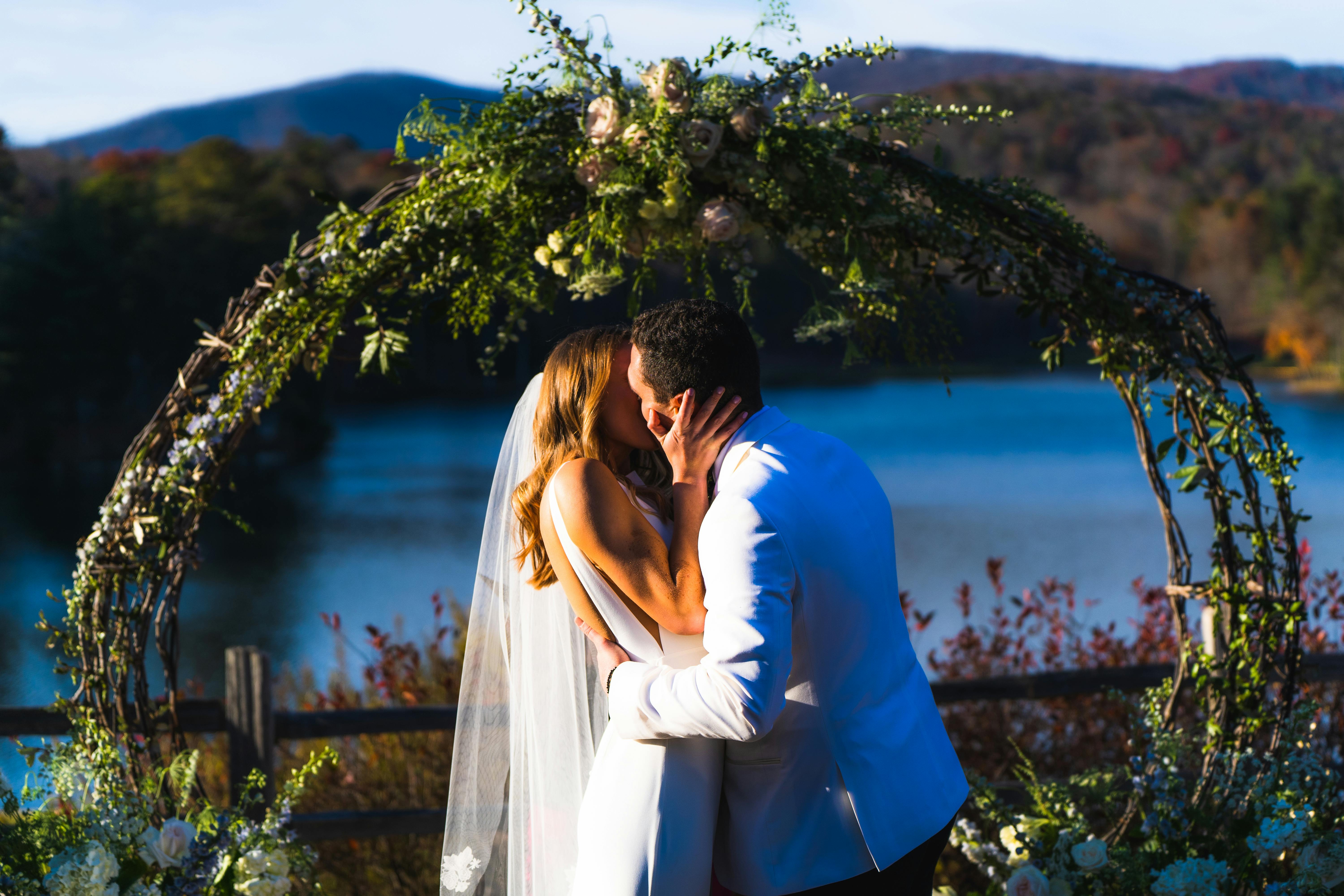 Man in Black Suit Holding Hands with Woman in White Dress · Free Stock ...