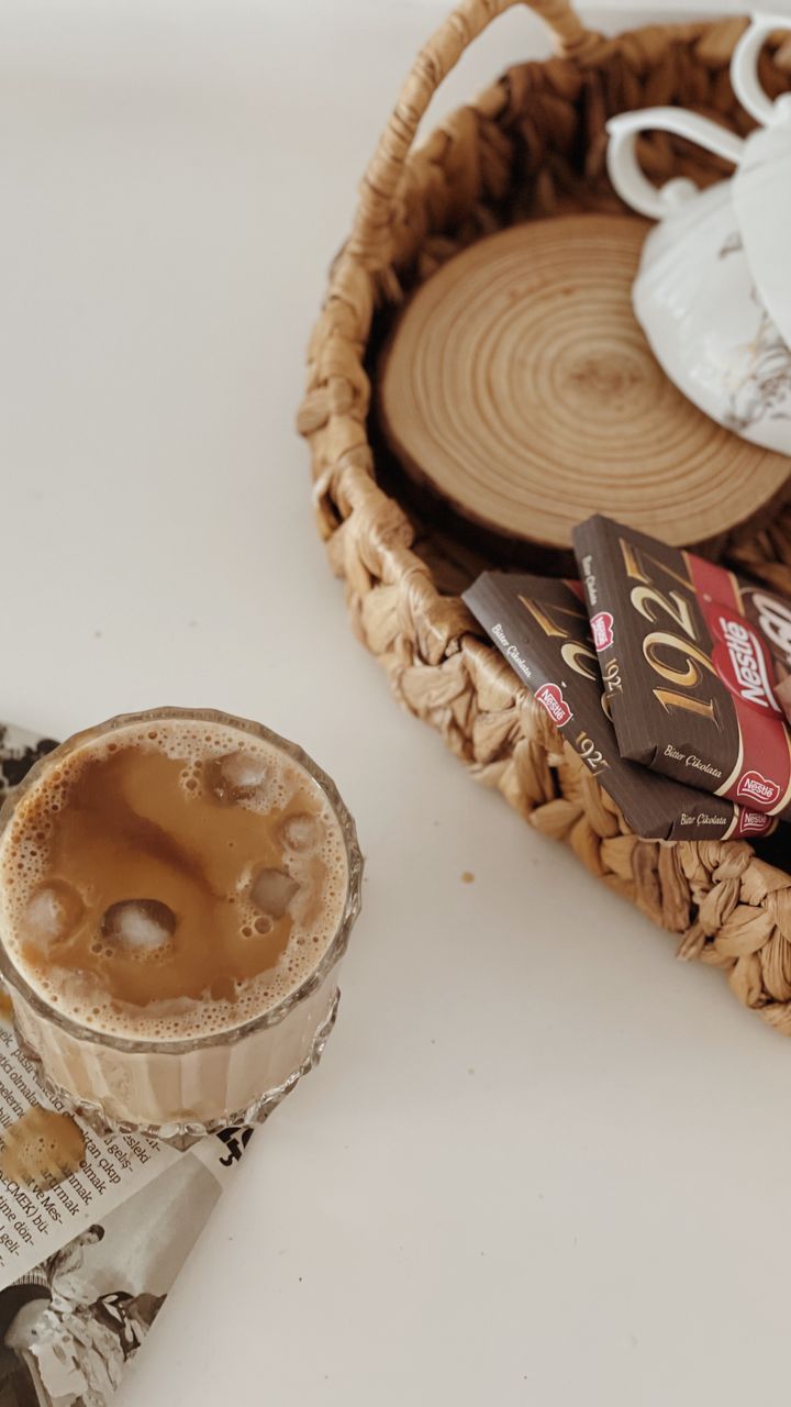 Natural woven storage basket holding coffee supplies on a dollar tree coffee bar design