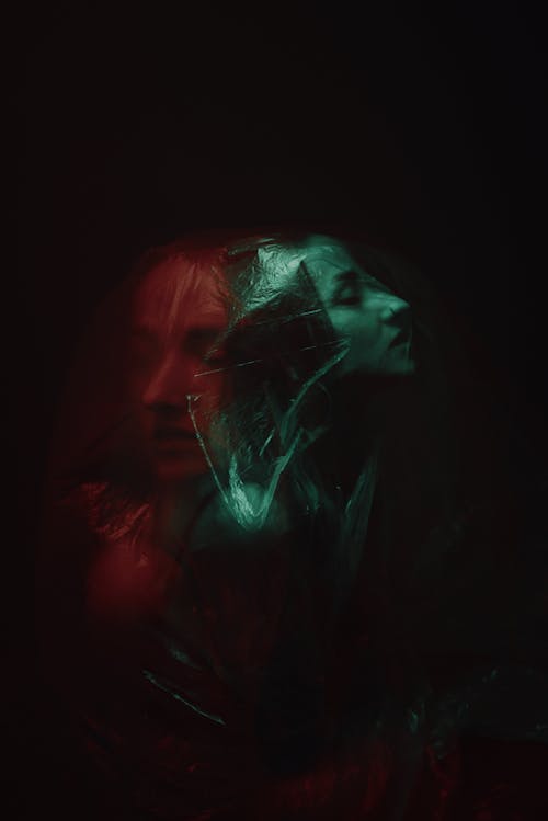 Two-colored Double Exposure Photo of Woman Trapped into Plastic Foil