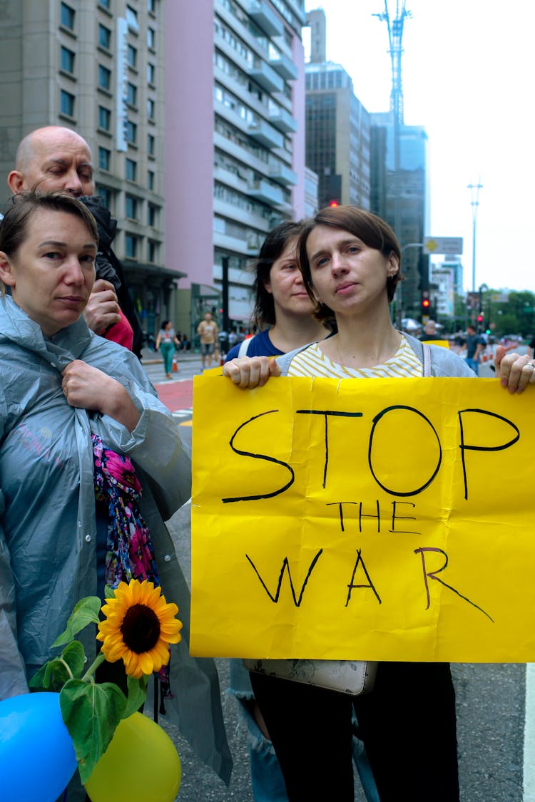 A Woman Holding A Banner On The Street