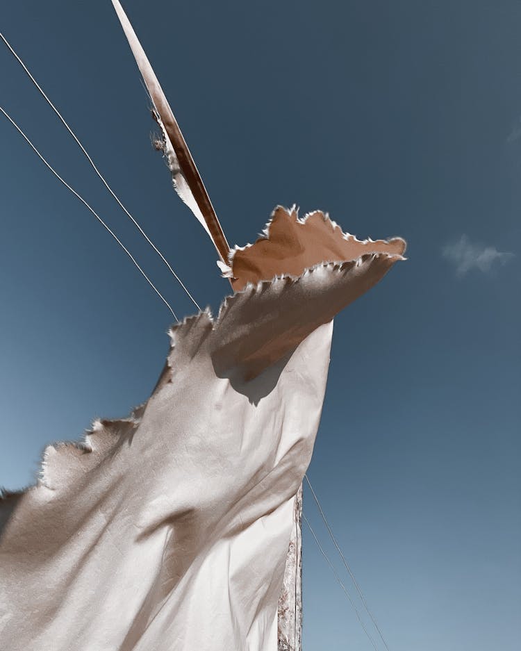 Ripped Textile Under Blue Sky