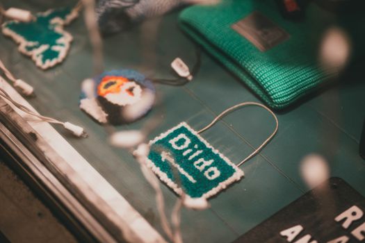 Artistic crochet souvenirs and crafts displayed in a retail store window.