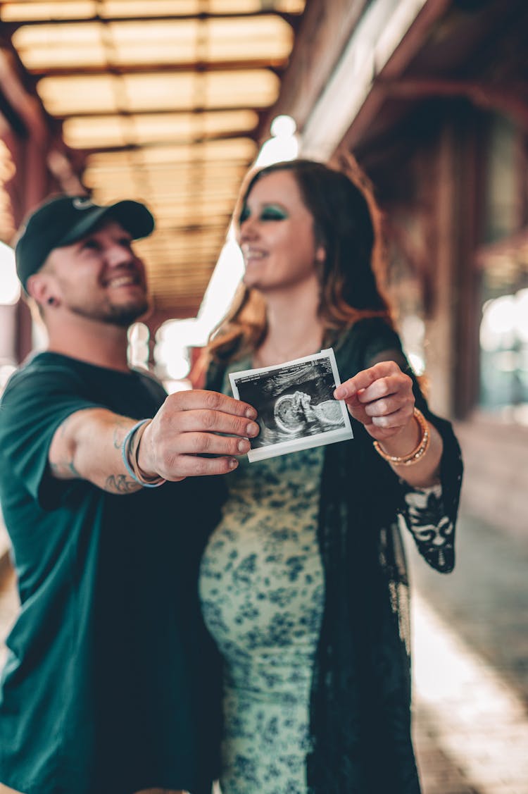 Man And Woman Holding A Sonogram