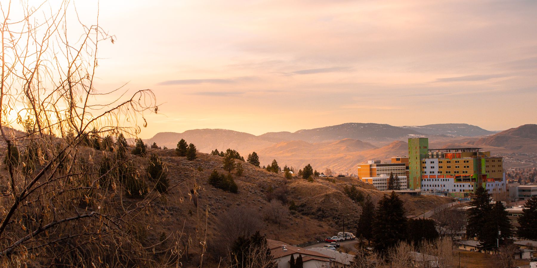 Beautiful sunset view over hills and urban buildings in Kamloops, BC, Canada.