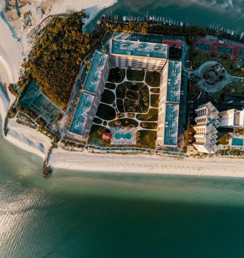Free Stunning aerial shot of Bonita Springs beachfront resort, capturing sea and lush green surroundings. Stock Photo