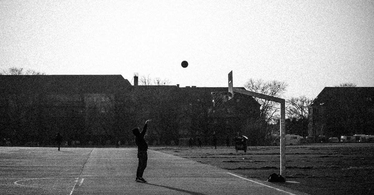 Grayscale Photo of a Person Shooting a Basketball · Free Stock Photo