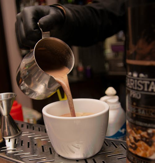 Free A Person Pouring Coffee in the Cup Stock Photo