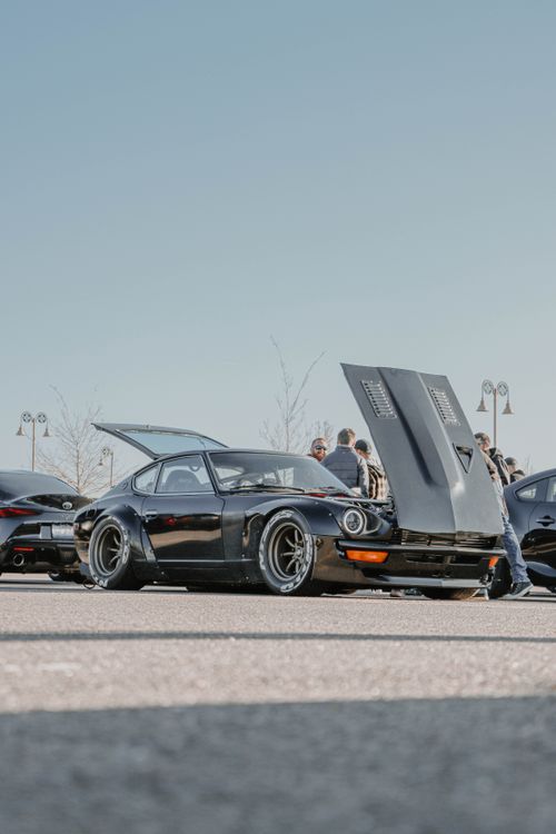 Free Black Datsun 240Z showcased at an outdoor car meet in Denver, capturing classic sportscar appeal. Stock Photo