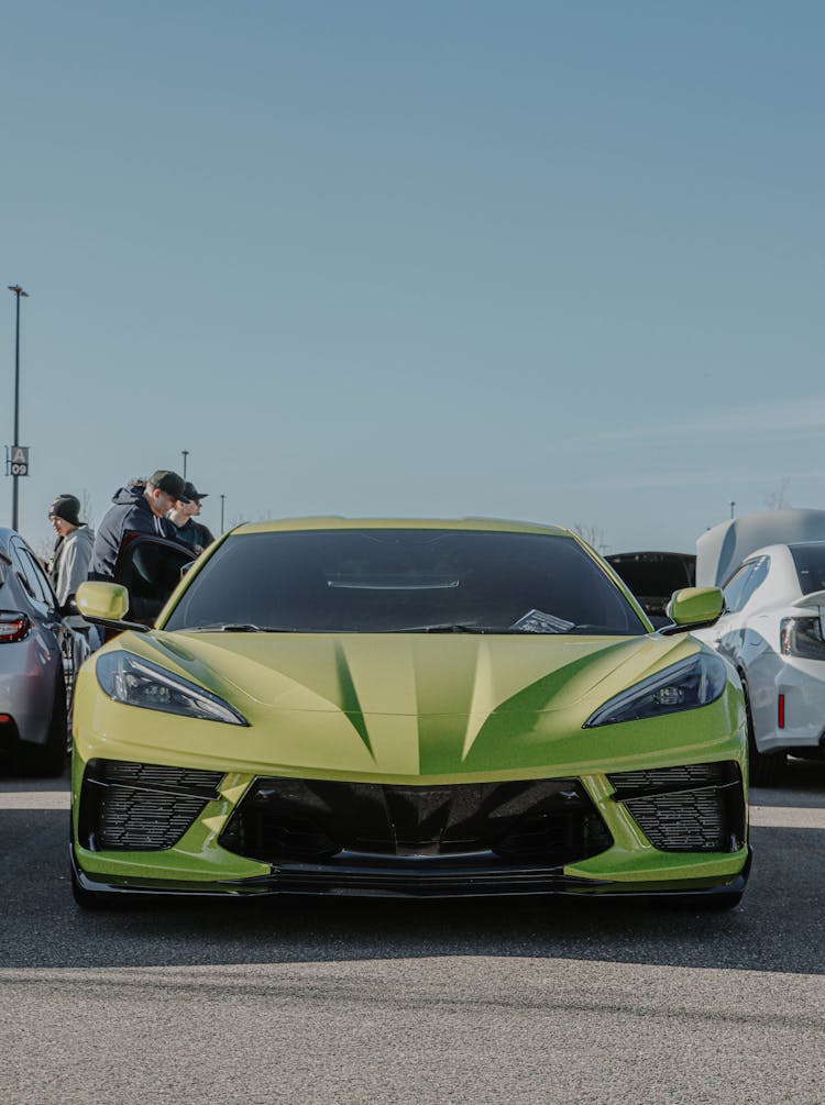 A Yellow Corvette On Gray Asphalt