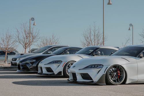 Free A lineup of luxury supercars at an outdoor car show, showcasing sleek design and performance. Stock Photo