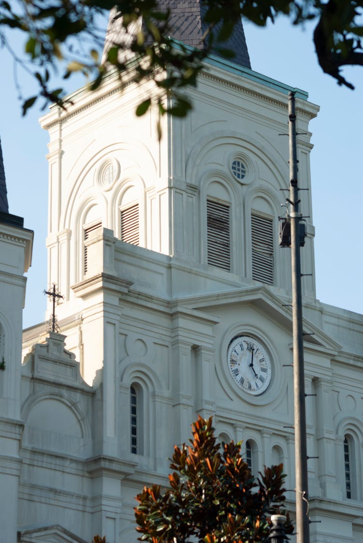 White Concrete Building With Clock