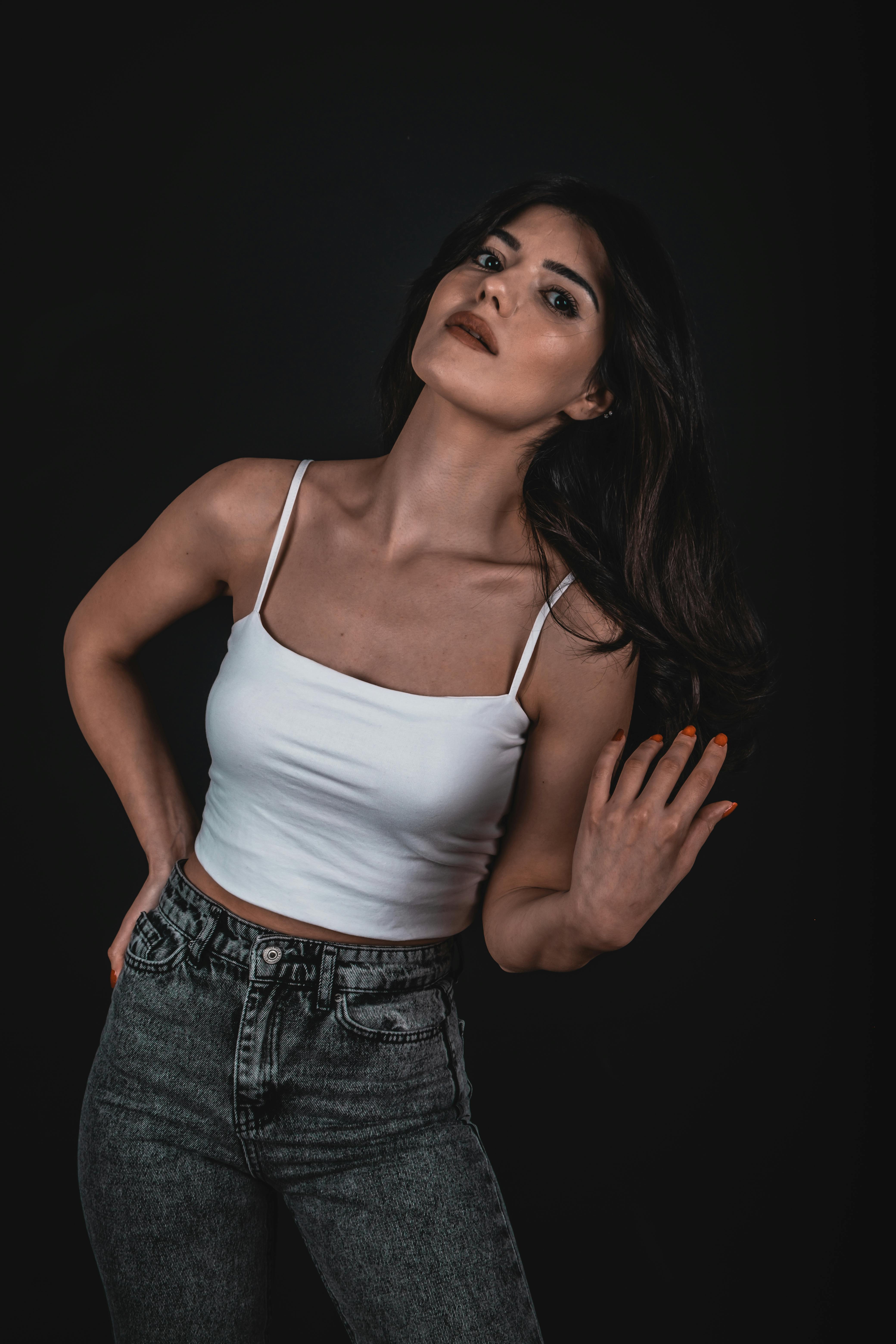 Woman in White Tank Top and Blue Denim Jeans · Free Stock Photo