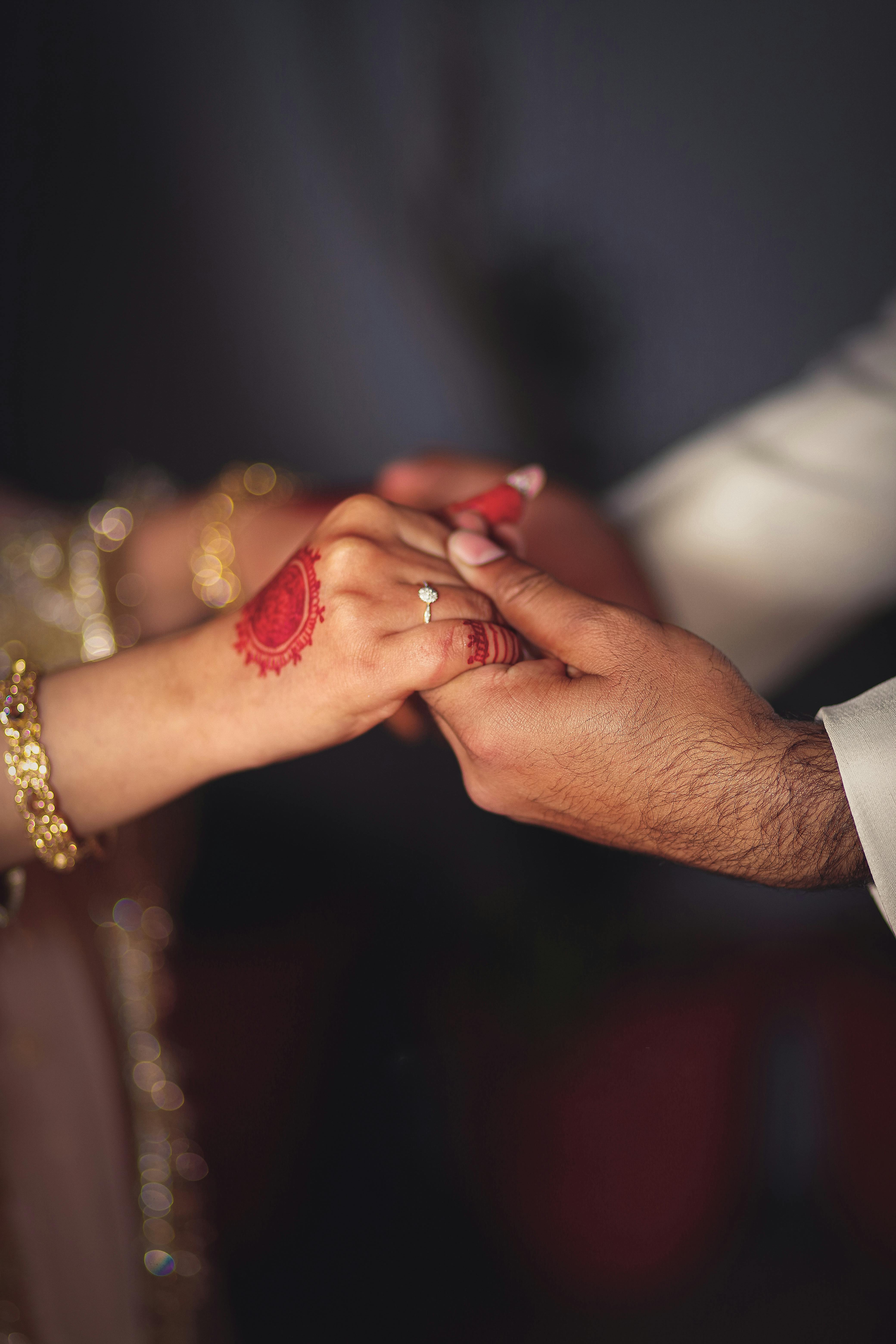 Woman wearing ring on man's hand on wedding ceremony close-up Stock Photo  by olegbreslavtsev