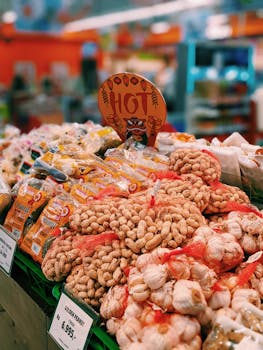Peanuts and snacks on vibrant display in Malang, Java's bustling street market.