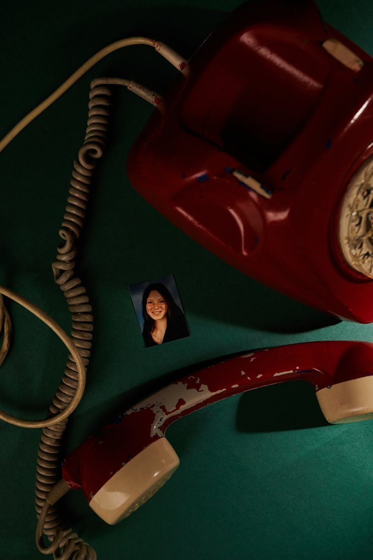 Red Telephone On Green Surface