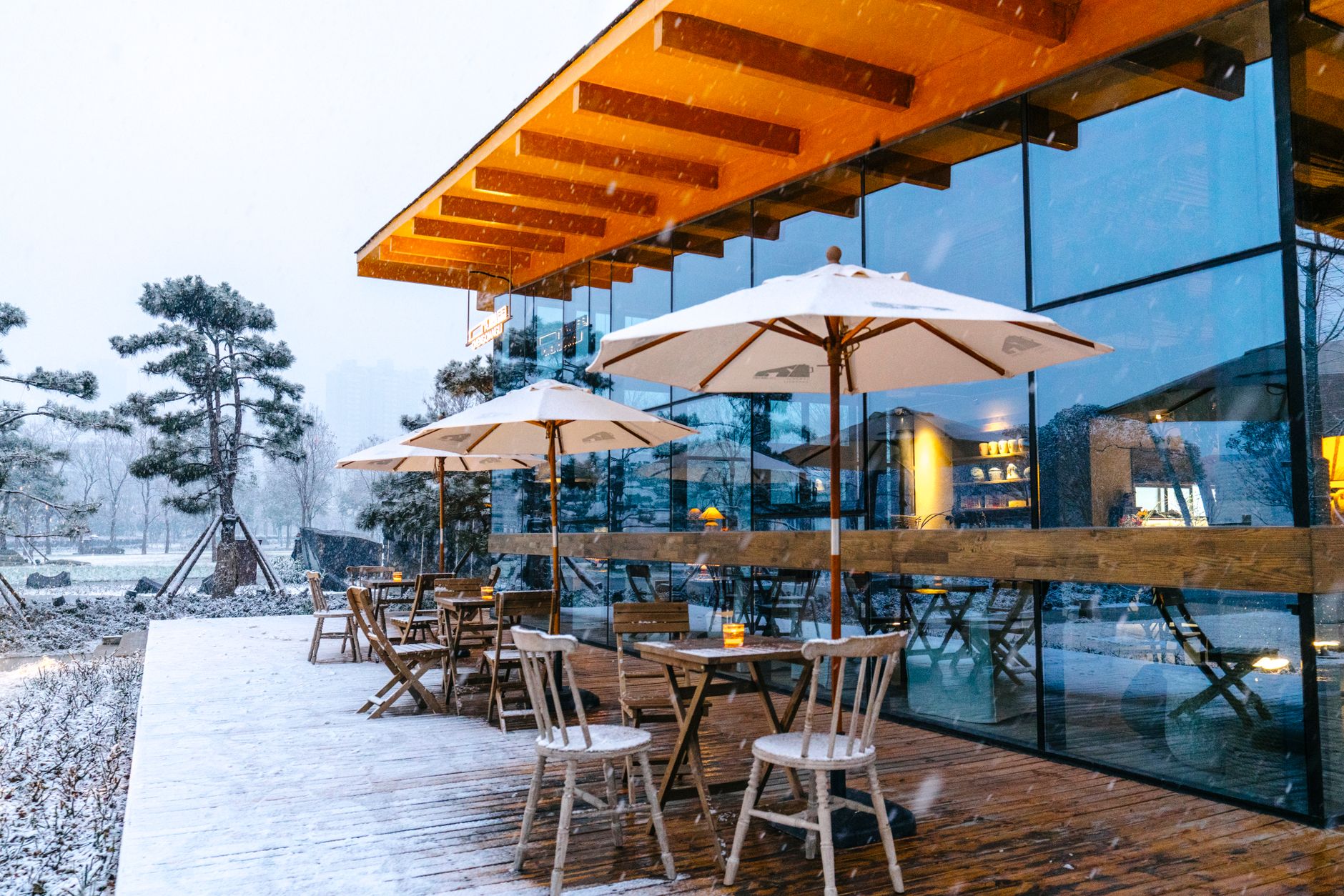 A wooden deck covered in a fresh layer of snow, with no roof overhead to shelter it or reduce the accumulated load