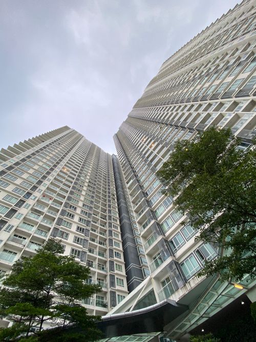 Free Dramatic low angle view of urban skyscrapers against a gray sky. Stock Photo
