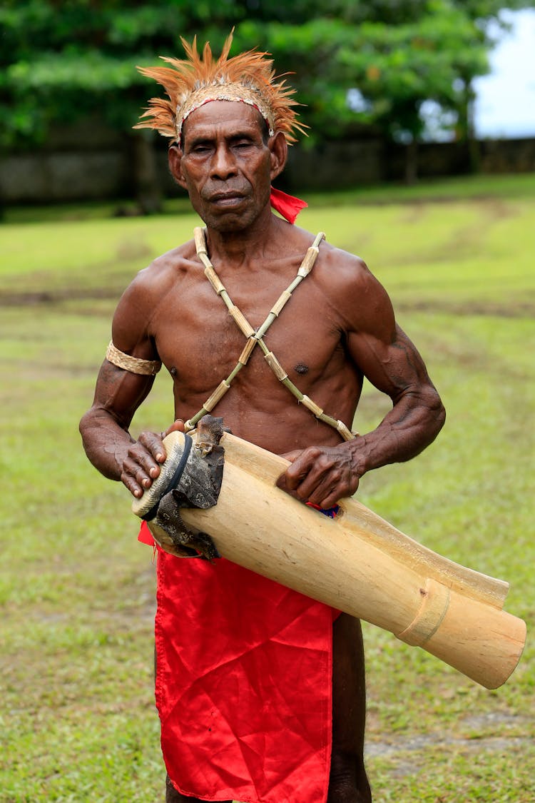 Native Man Holding Wooden Drum