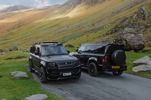 Parked Black Land Rover Defenders