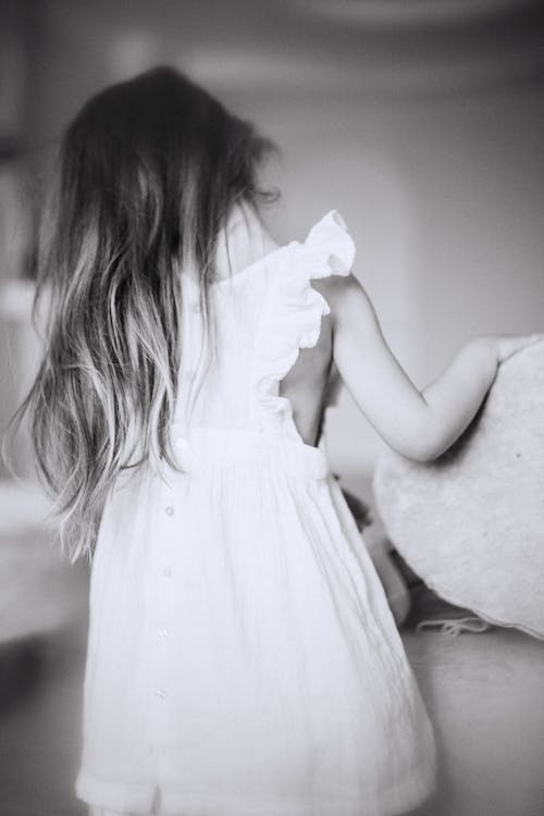 Grayscale Photo of Girl in White Dress