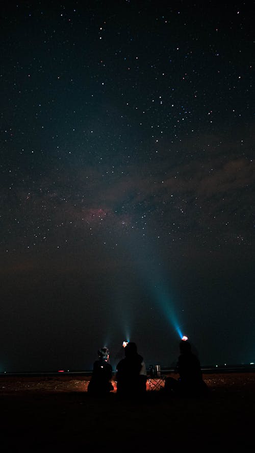 People Holding Flashlights Stargazing