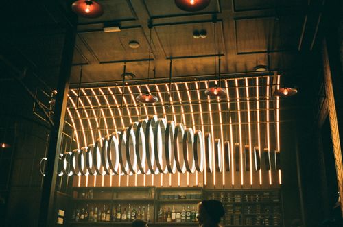 Free Contemporary bar showcasing illuminated LED lights and stylish interior design. Stock Photo