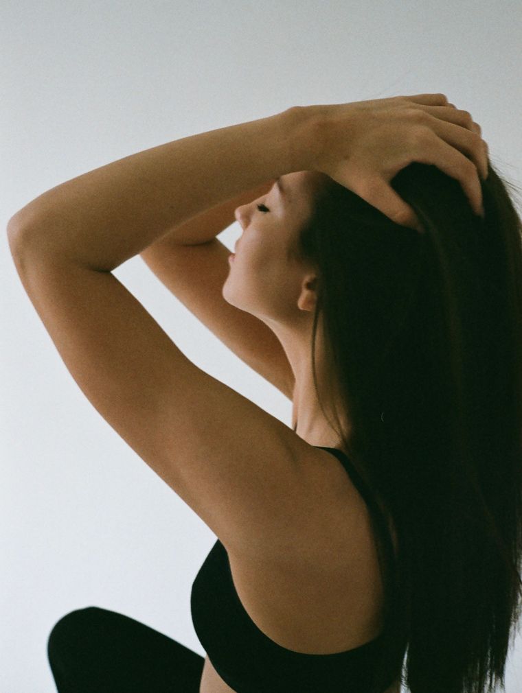 Back view of a woman fixing her hair