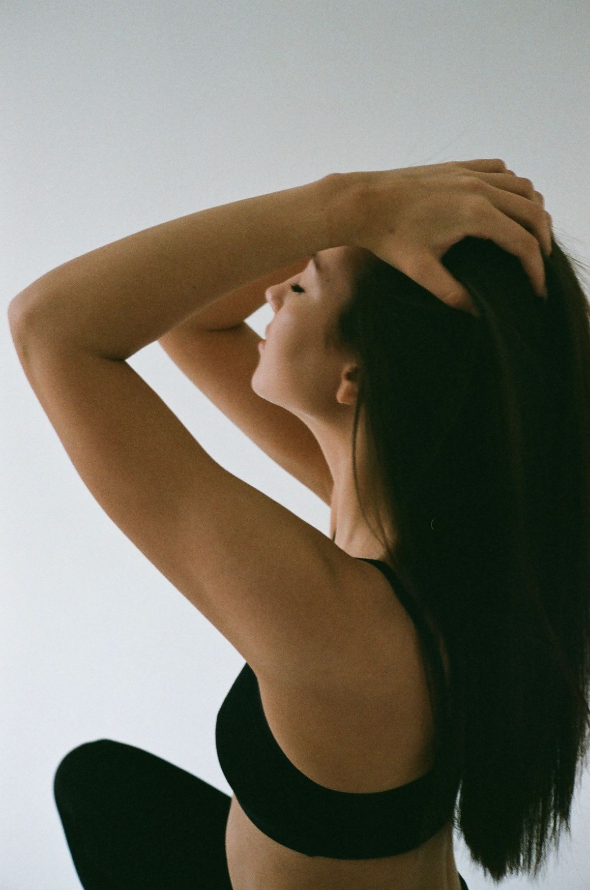 Woman with elegant styled dark hair, shown from behind in a salon setting