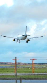 A commercial airliner approaches landing at Billund Airport, showcasing modern aviation and transportation.